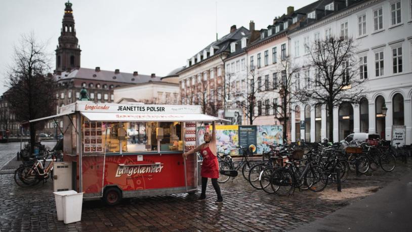 Woman opening hot dog stand "Jeanettes Pølser" in Copenhagen