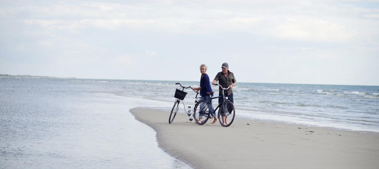 Couple with bike on Fanø beach