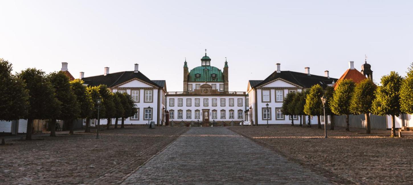 Bild vom Schloss Fredensborg und der Allee, die zum Schlosstor führt.