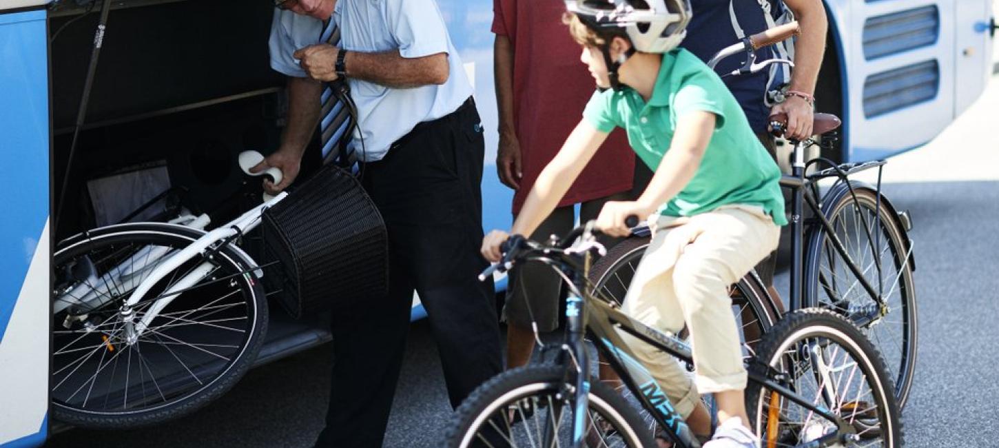 A family taking their bicycles with in a bus in Thisted