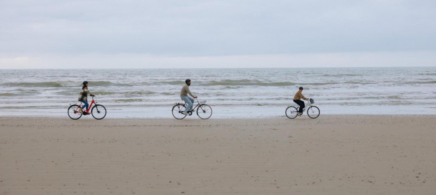 Family cycling on the beach of the Danish North Sea coast