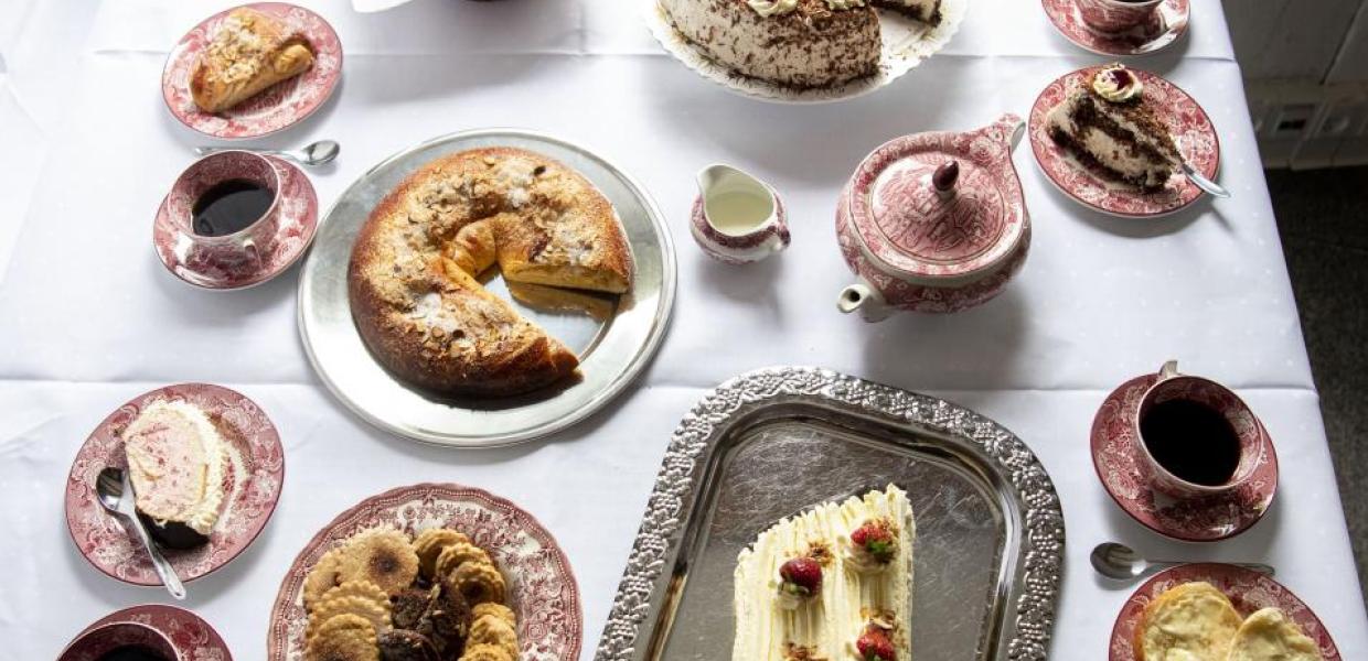 Kaffeetafeln, Bild eines Tisches mit Kuchen und Tassen mit Kaffee