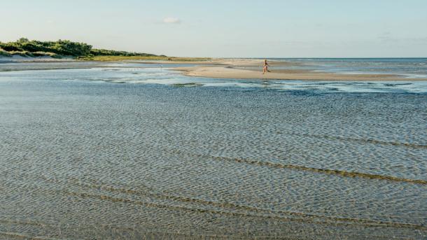 Child running at beach of Øster Hurup, North Jutland