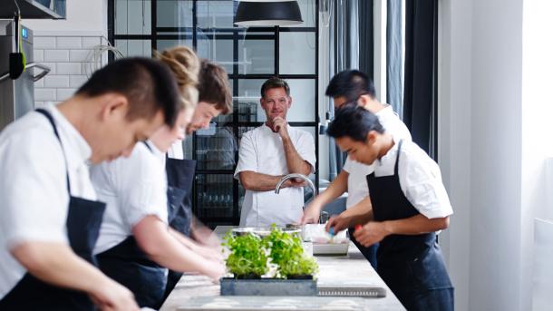 Chefs prepare food in the kitchen at VeVe, a restaurant in Copenhagen, Denmark