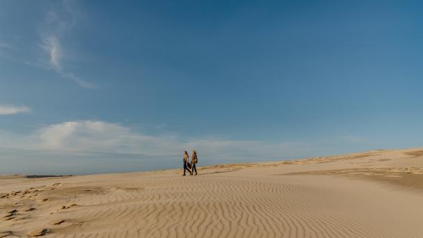 Zwei Frauen laufen auf er WAnderdüne Råbjerg mile