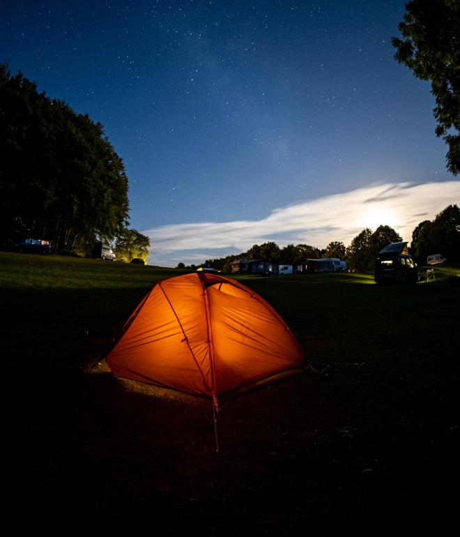 A tent pitched at Camp Møns Klint on a starry night.