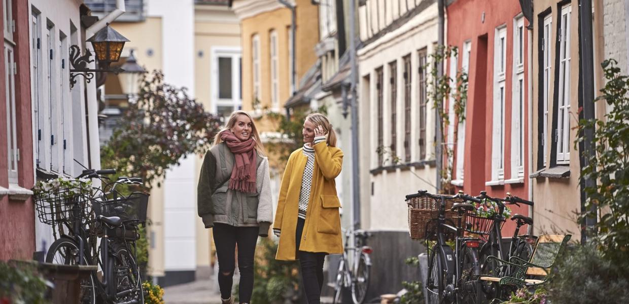 Woman walking through Aalborg in autumn