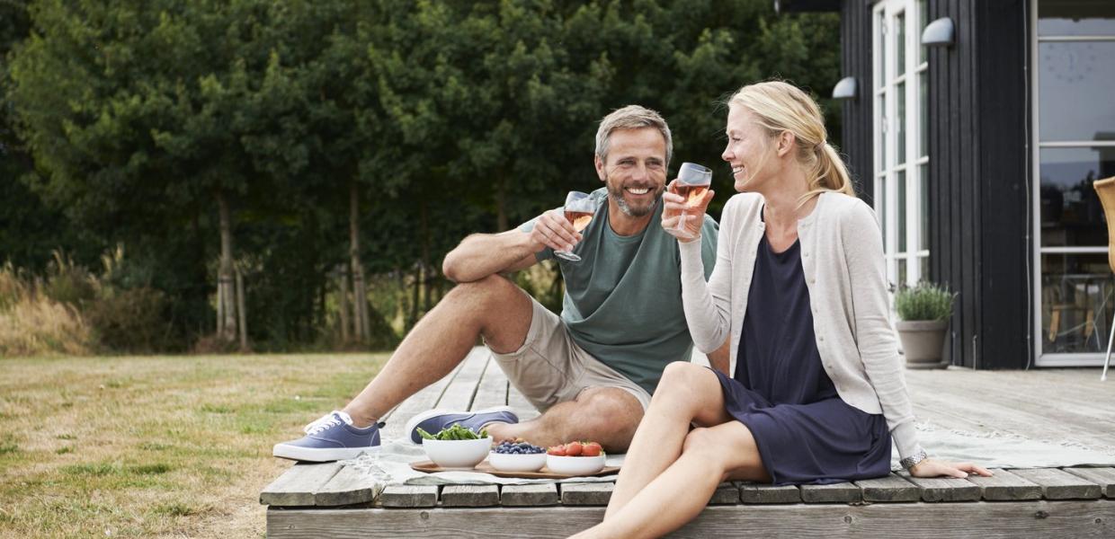 A couple outside on a terrace in a summerhouse in Nysted near the South Coast of Lolland.