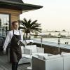 Waiter with wine on terrace at Skodsborg Spa Hotel