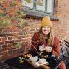 A woman having breakfast outside in Copenhagen, Denmark