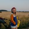 A lady stands with a bike in Hindsgavl National Park, Denmark