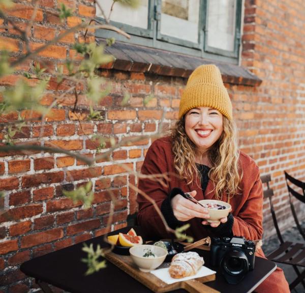 En kvinne spiser lunsj ute på cafe på høsten i København, Danmark