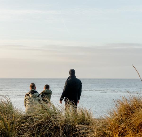 Family looking to the sea at Blåvand beach, West Jutland