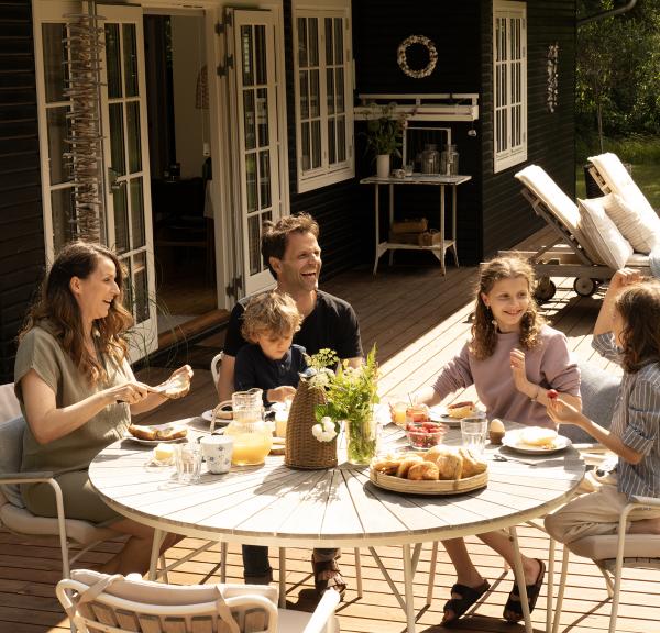 Family in front of a summerhouse in Denmark