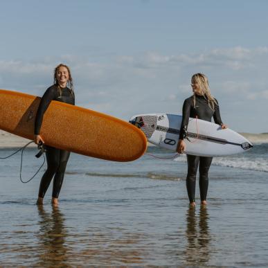 Two female surfers in Hvide Sande on the Danish West coast.