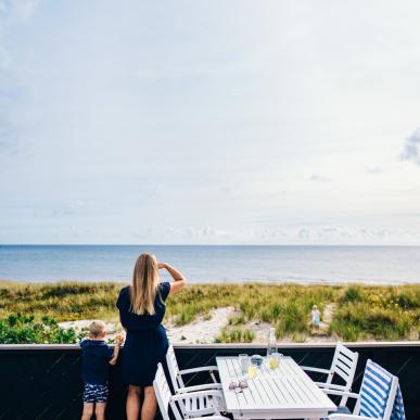  Mother and son on a terrace at  Grenå beach, Denmark