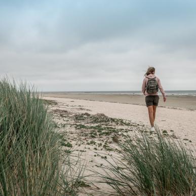 Woman walking at the beach of Fanø