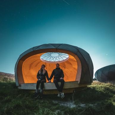 Et par som sitter i et shelter på Brorfelde observatoriet