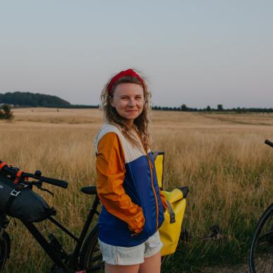 Woman with bikes on cycling trip at Naturparken Hindsgavl Dyrehave near Middelfart, Fyn