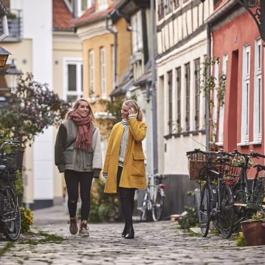 Woman walking through Aalborg in autumn