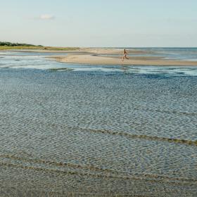 Child running at beach of Øster Hurup, North Jutland