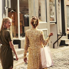 Two women walk along the street in Aarhus, Denmark