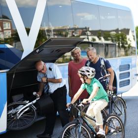 A family taking their bicycles with in a bus in Thisted