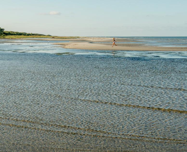 Child running at beach of Øster Hurup, North Jutland