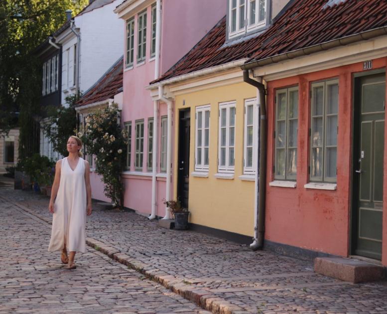 Woman walking through the oly city of Odense, Fyn