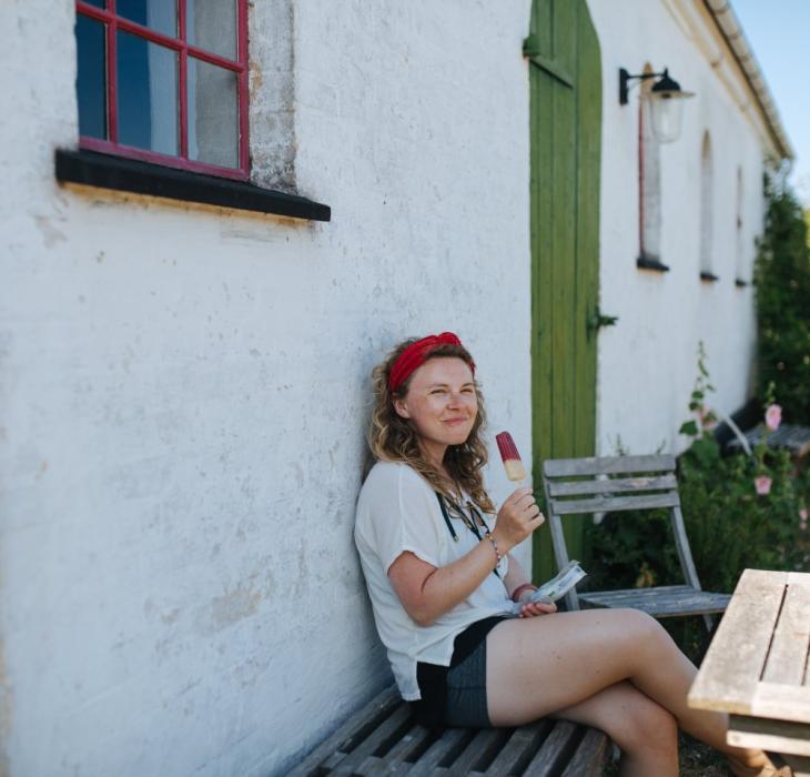 Woman enjoying an ice cream on a break from cycling,  BLÅBÆR GÅRDBUTIK  