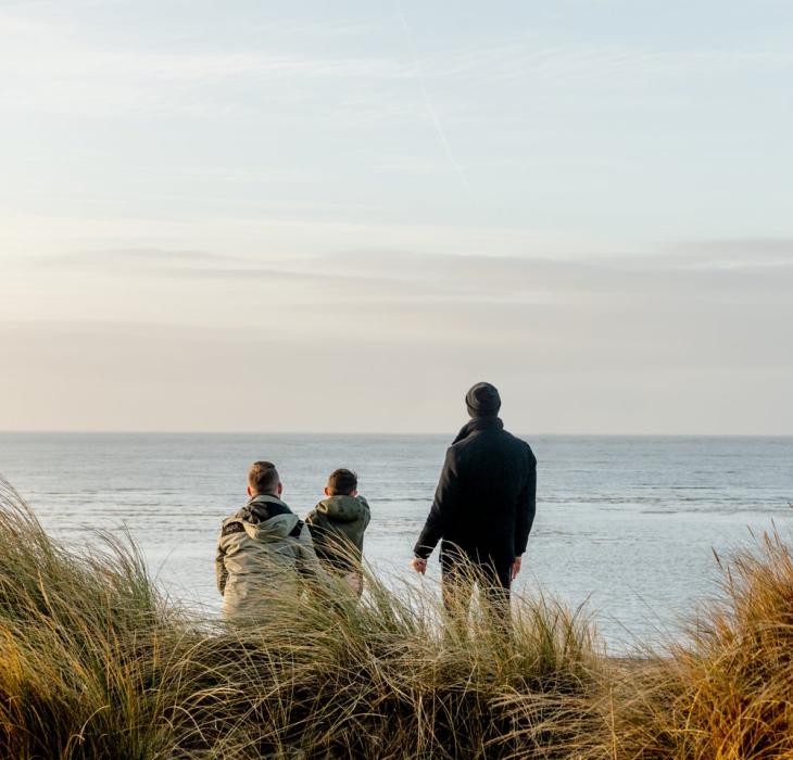 Family looking to the sea at Blåvand beach, West Jutland