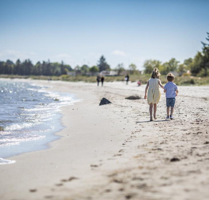 Children playing at Saksild beach in coastal land